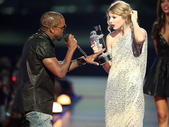 Kanye West jumps onstage after Taylor Swift won the "Best Female Video" award during the 2009 MTV Video Music Awards in 2009. Picture: Christopher Polk/Getty Images