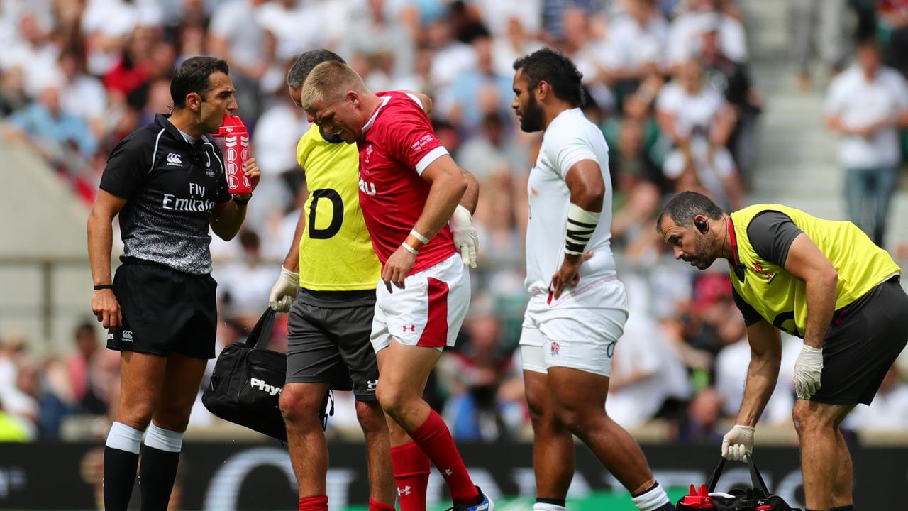 Gareth Anscombe of Wales receives medical treatment.