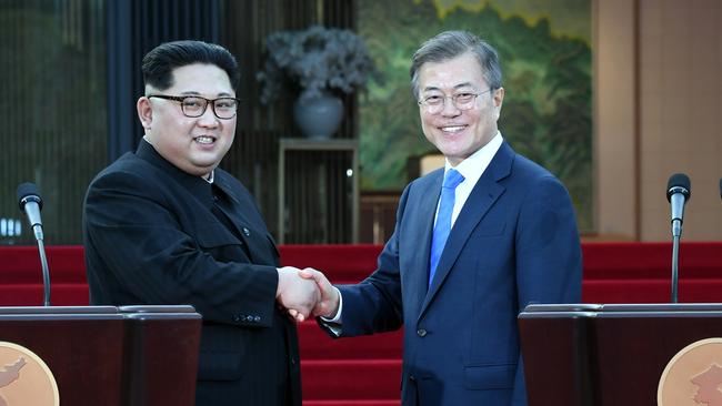 North Korean leader Kim Jong-un and South Korean President Moon Jae-in shake hands after signing a joint declaration on the southern side of the truce village of Panmunjom in the Demilitarised Zone last month. Picture: Yonhap