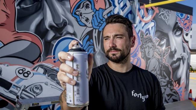 Artist Alex Lehours at work for a story on griffin-inspired murals at the new Freedom Fuels service station on Bundall Rd. Picture: Jerad Williams