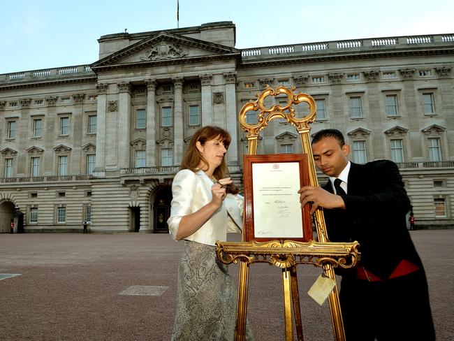 Top job ... The Queen's Press Secretary Ailsa Anderson with Badar Azim a footman place the announcement on the easel to announce the birth of Prince George. Picture: John Stillwell/WPA Pool/Getty Images