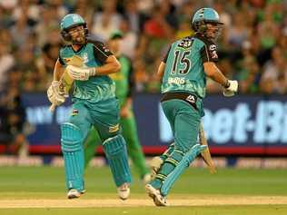 Alex Ross (left) and Joe Burns score the winning runs at the MCG. Picture: DAVID CROSLING