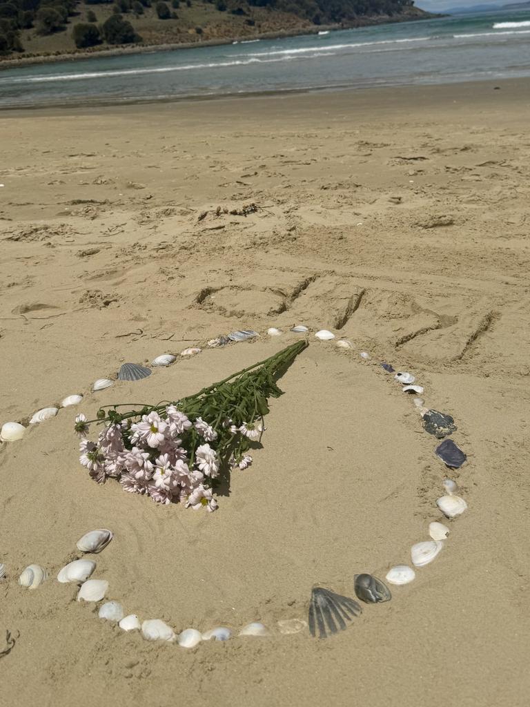 People left tributes at Carlton Beach, where a man drowned on Sunday trying to rescue four children swimming. Picture: supplied.