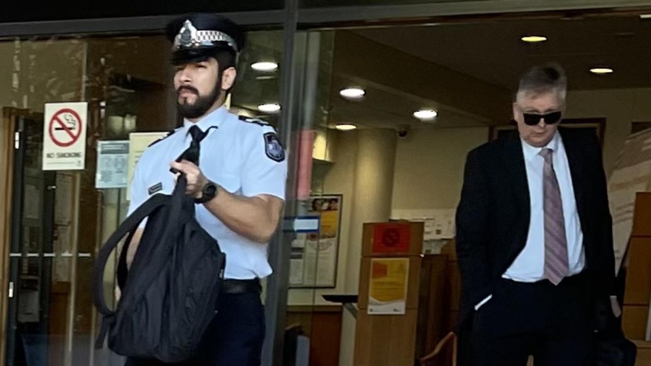 Queensland Police Service Senior Constable Renzo Martinez and Ethical Standards Command Detective Senior Sergeant Neil Parker leave court after giving evidence at an inquest into a death in custody incident where a man died enroute to Rockhampton watch house in November 2019 after being arrested and restrained in the Leichhardt Hotel car park, on Bolsover Street, across the road from the police station and watch house.