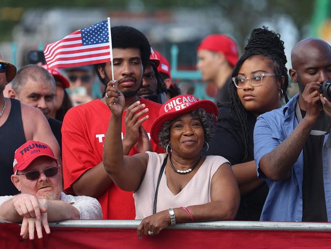 Trump supporters waved flags and wore hats in support of his campaign. Picture: Getty Images/AFP