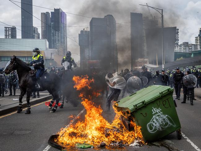 Anti-war activists protest the Land Forces 2024 International Land Defence Exposition at the Melbourne Convention and Exhibition Centre. Protesters attempt to establish a burning barricade on the Clarendon Street Bridge. Picture: Jake Nowakowski