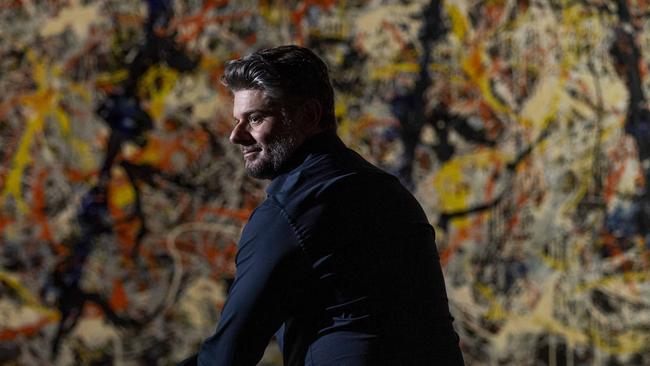 National Gallery of Australia director Nick Mitzevich with Jackson Pollock’s Blue poles, which will be cleaned on display. Picture: Sean Davey