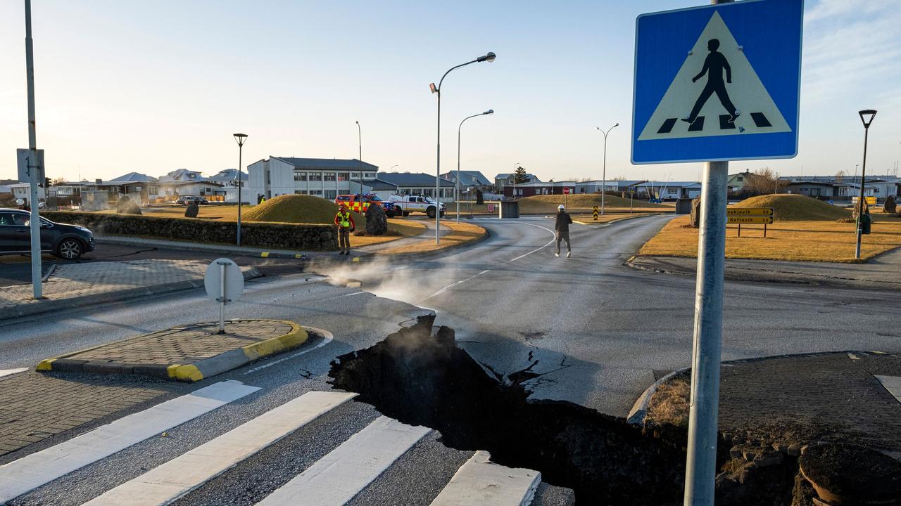 It’s an eerie wait for Iceland as smoke seeps from cracks cutting across the main road of Grindavik as the threat of a volcanic eruption keeps the Nordic island nation on edge. Picture: Kjartan Torbjoernsson/AFP/Iceland OUT
