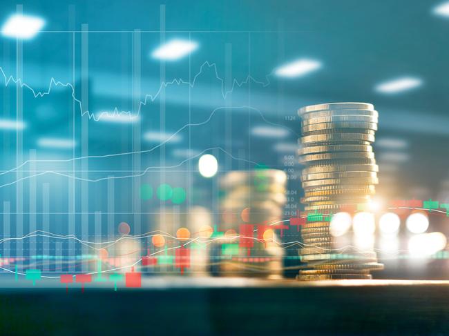 Finance and business investment concept. Graph and rows with statistic growth of coins on table.