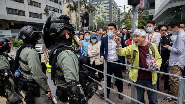 Riot police arrive to disperse people gathering in support of pro-democracy protesters during a lunch break rally in the Kowloon Bay area in Hong Kong. Picture: AFP