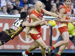 ACTION PACKED: Paul Puopolo of Hawthorn and Gary Ablett of The Gold Coast Suns in action during their Round 21 AFL game at the MCG in Melbourne. Picture: Aap