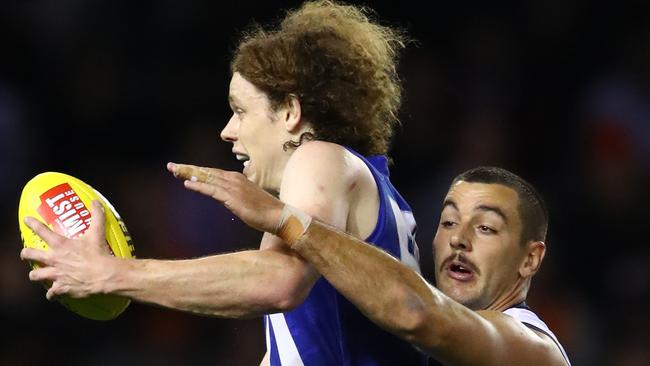 Taylor Walker tries to wrap up North Melbourne’s Ben Brown. Picture: Scott Barbour/Getty Images