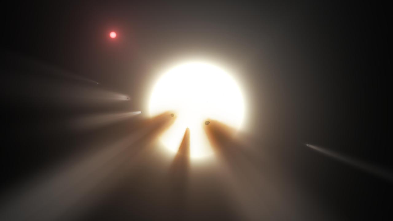 Αυτή η εικόνα δείχνει ένα αστέρι πίσω από έναν θρυμματισμένο κομήτη.  Οι παρατηρήσεις του άστρου KIC 8462852 από τα διαστημικά τηλεσκόπια Kepler και Spitzer της NASA υποδηλώνουν ότι τα ασυνήθιστα φωτεινά σήματα του είναι πιθανώς από σκονισμένα θραύσματα κομήτη, τα οποία εμπόδισαν το φως του άστρου καθώς περνούσαν μπροστά του το 2011 και το 2013. Οι κομήτες πιστεύεται ότι είναι ταξιδεύοντας γύρω από το αστέρι σε μια πολύ μεγάλη, έκκεντρη τροχιά.  Φωτογραφία: NASA