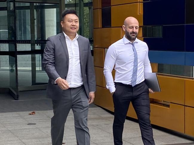 Blockchain Global founder Allan Guo (grey suit) outside the Federal Court with his solicitor George Tsogas (white shirt) on 12 March, 2024.