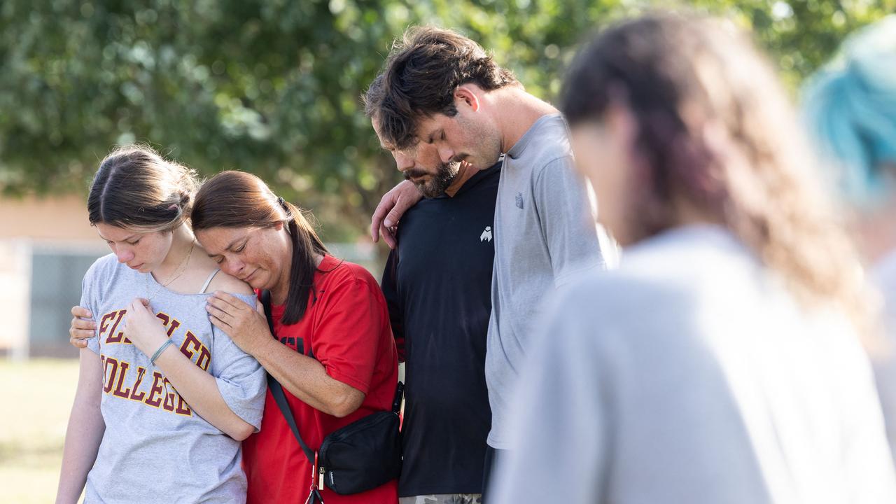 Students and their families pray at a memorial outside the school on Thursday. Picture: Jessica McGowan/Getty Images North America/AFP