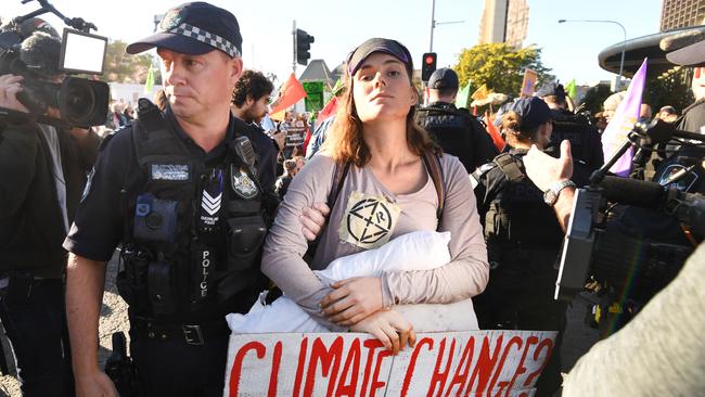 An Extinction Rebellion protester is arrested in Brisbane. Picture: AAP.
