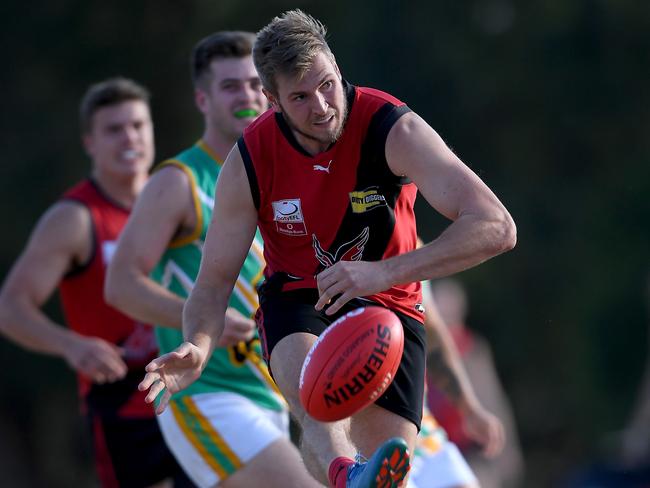 Rob Maibaum gets a kick away for Knox. Picture: Andy Brownbill