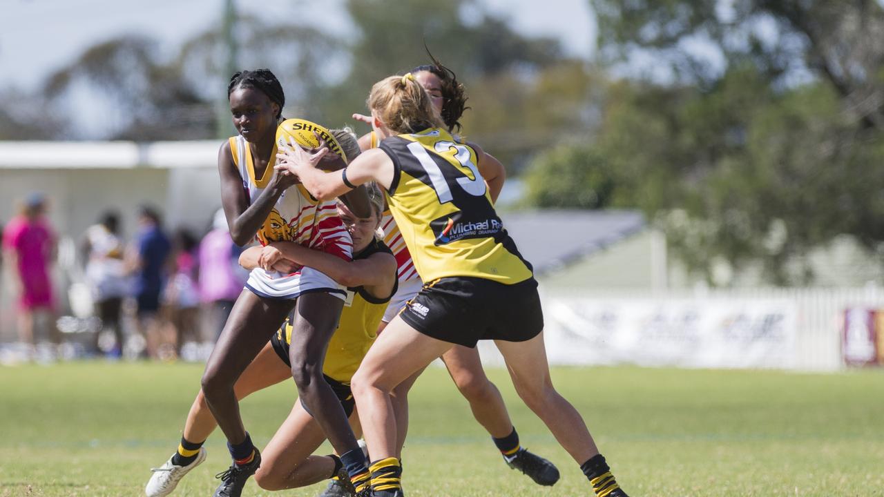 Apajok Deng of University Cougars is tackled by Sarah Browne of Toowoomba Tigers in AFL Darling Downs Toowoomba Toyota Cup senior women grand final at Rockville Park, Saturday, September 2, 2023. Picture: Kevin Farmer