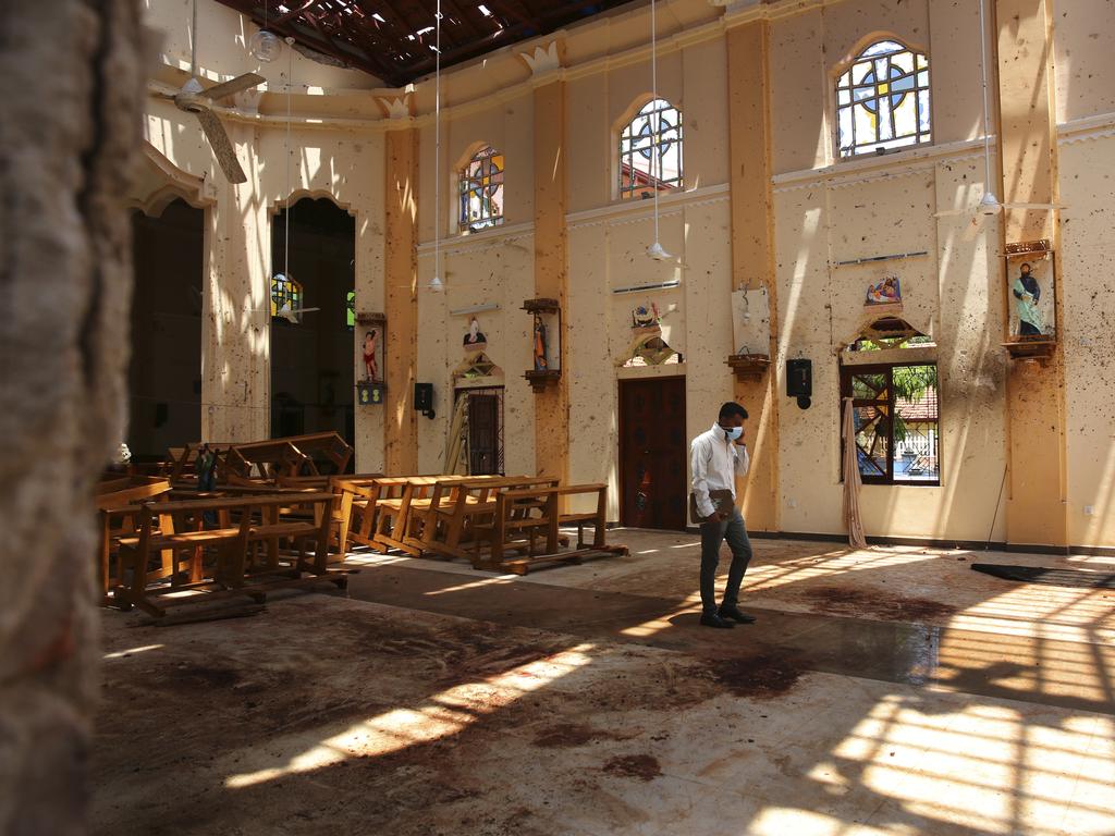 A surveyor walks inside the damaged St. Sebastian's Church where a suicide bomber blew himself up on Sunday Easter. Picture: AP