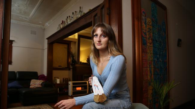 Darian Quadrio, pictured with her medals in her Sydney home, had her dream of becoming an Olympic swimmer was ruined Picture: Britta Campion