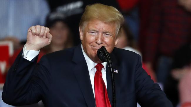 President Donald Trump pumps his fist as he speaks during a campaign rally. Picture: AP