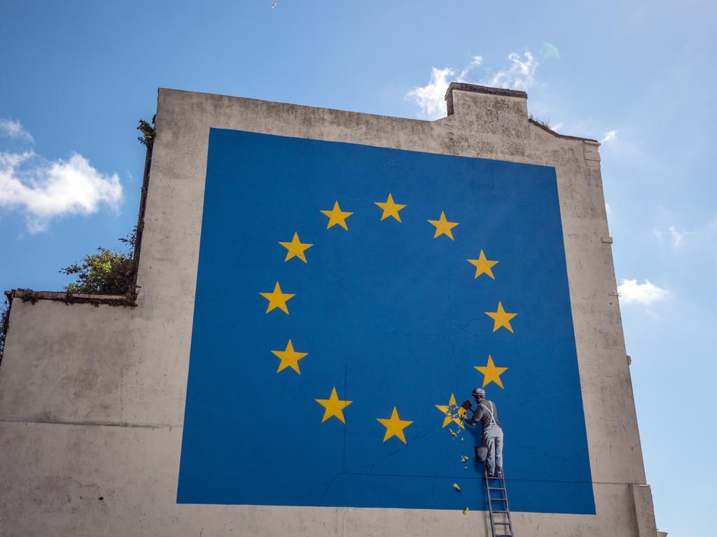 Another Banksy mural, depicting a workman chipping away at one of the stars on a European Union. Picture: Getty