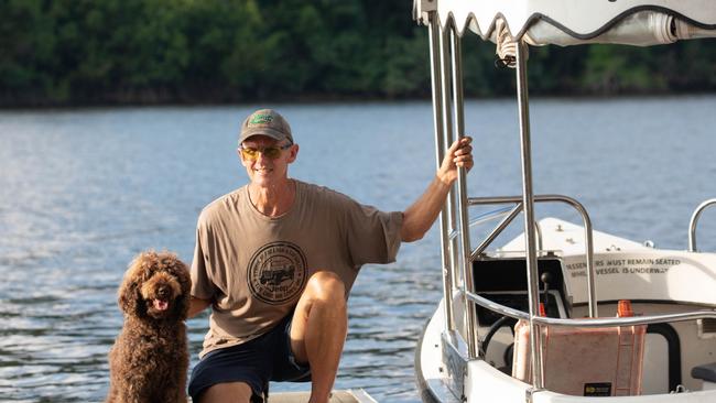 Crocodiles are being shot because people are making poor choices and not being crocwise, according to Daintree River wildlife expert David White, of Solar Whisper Crocodile and Wildlife Cruises, pictured with his dog Dougie. Photo: Mark Murray