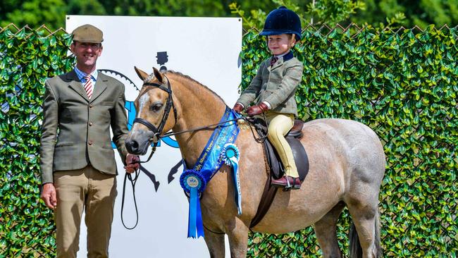 All smiles: Harry Armistead Riemer on his pony Pant-y-Flynon Cariad, with leader Luke Dawes. Picture: Lisa Gordon