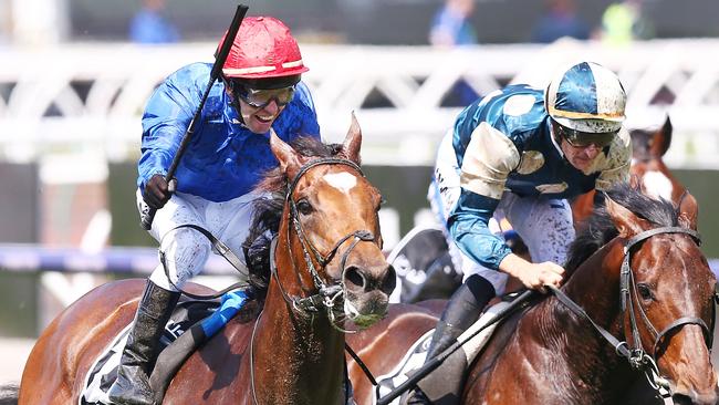 Kerrin McEvoy (left) rides Cross Counter to victory in the Melbourne Cup.