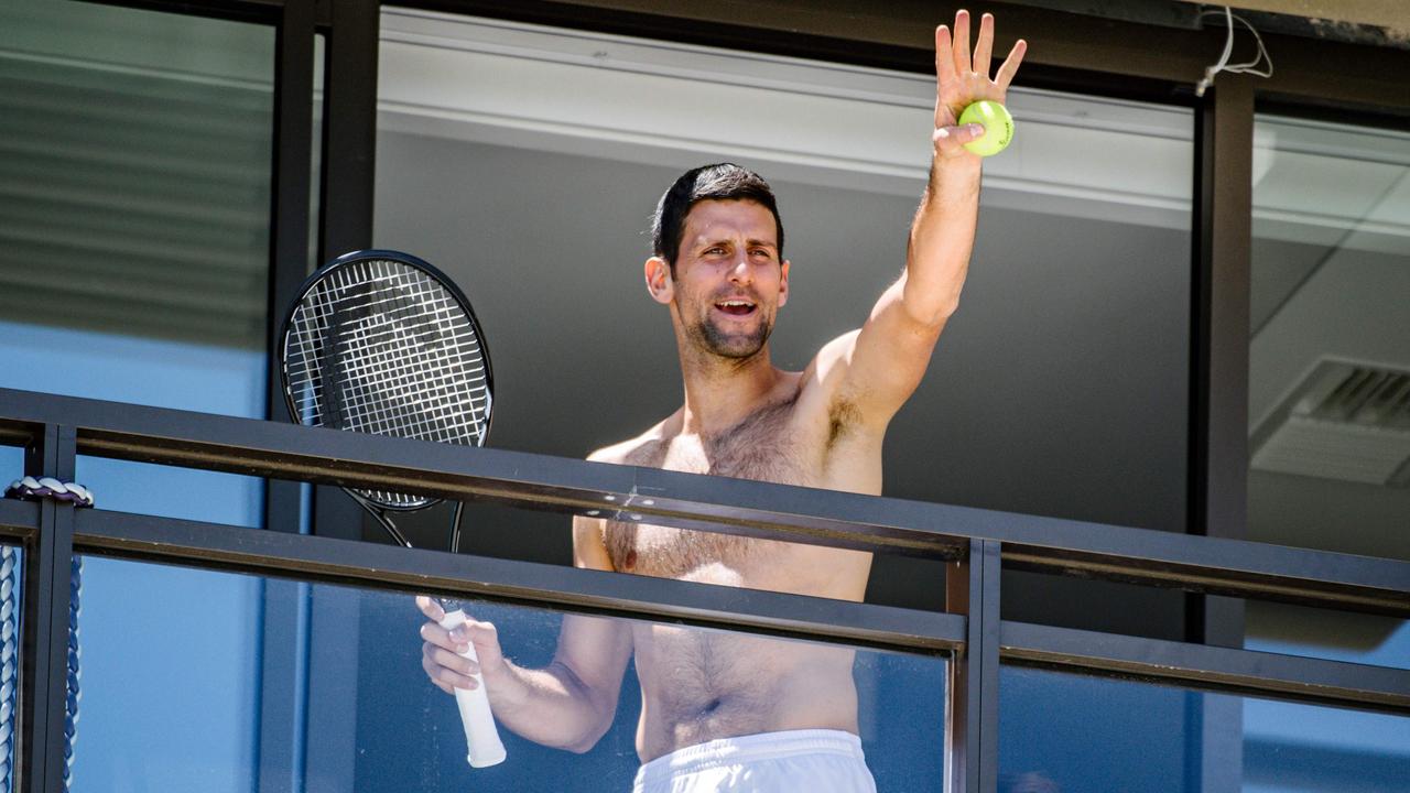 Men's world number one tennis player Novak Djokovic of Serbia waves to fans from a hotel balcony in Adelaide. Photo by Morgan SETTE / AFP.