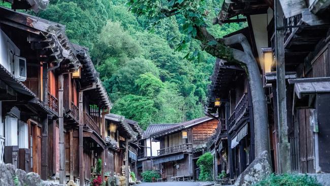 Japanese traditional wooden buildings for the travelers walking at historic old street in Narai-juku, Japan.