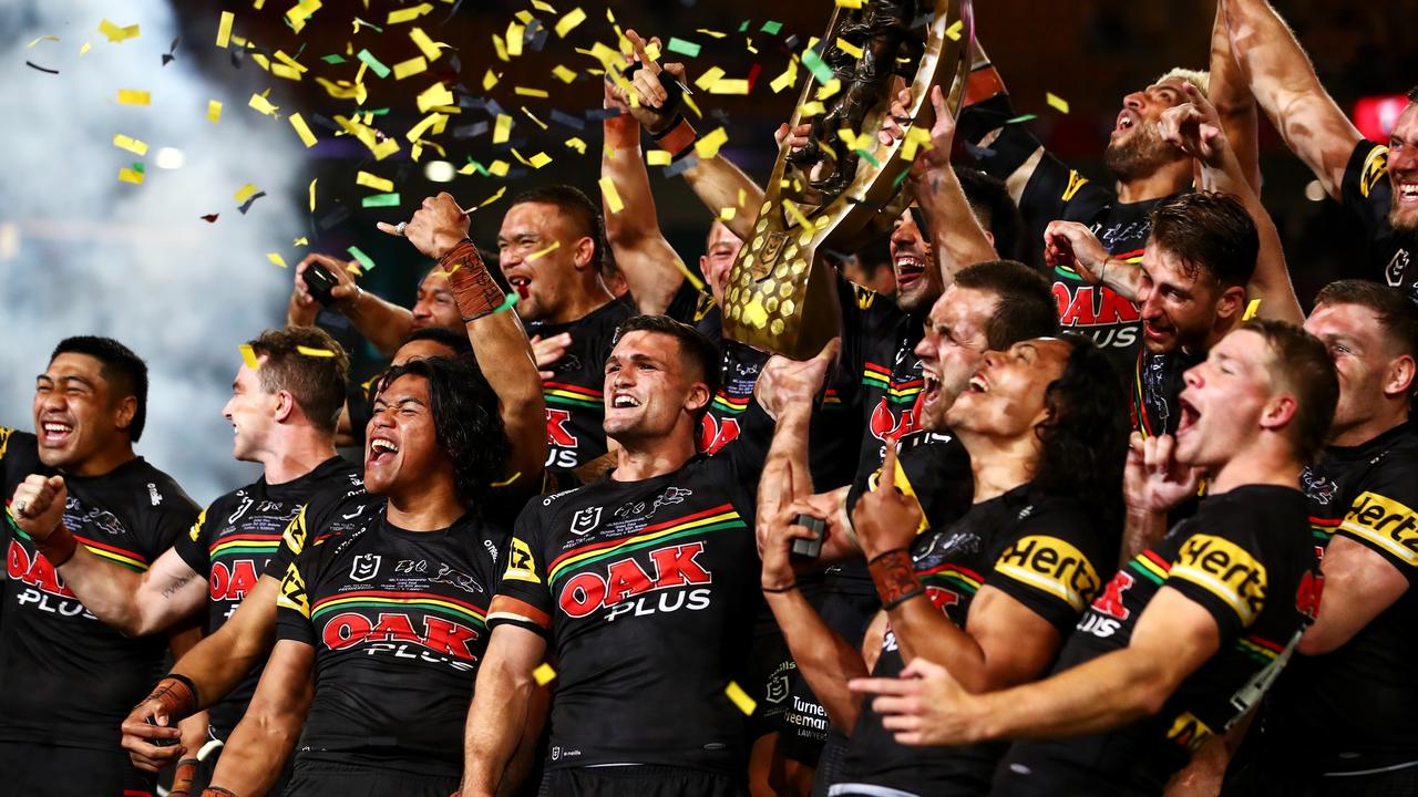 Panthers players celebrate with the NRL premiership trophy. Picture: Chris Hyde/Getty Images