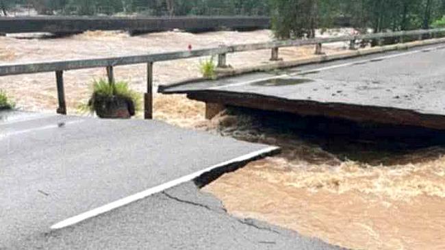 Ollera Creek Bridge was cut in half from flood water on the Bruce Highway north of Townsville.