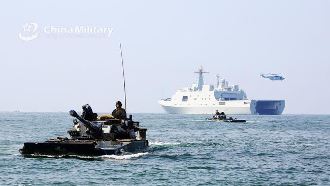 Amphibious armored vehicles attached to a brigade of the PLA Navy Marine Corps make their way to the beach-head during a maritime amphibious assault training in the west of south China's Guangdong Province.