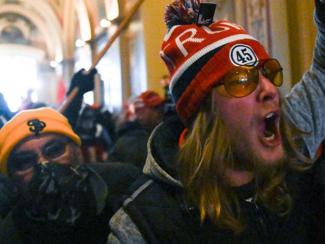 Supporters of US President Donald Trump protest inside the US Capitol on January 6, 2021, in Washington, DC. - Demonstrators breeched security and entered the Capitol as Congress debated the a 2020 presidential election Electoral Vote Certification. (Photo by ROBERTO SCHMIDT / AFP)