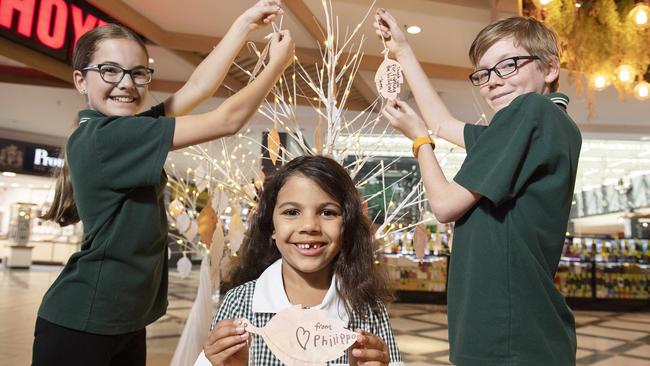 Emma, Philippa and James write their messages of support for heroic firefighters. Picture: Ellen Smith