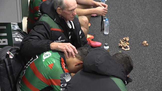 A tearful Latrell Mitchell receives support from Bunnies teammates and coach Wayne Bennett after Souths win over the Warriors.