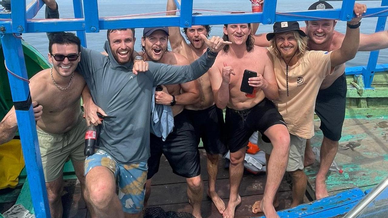 Australian surfers, who were rescued after two days in the water after a boating accident, are taken to nearby Pinang Island by Indonesian rescue crews. Supplied