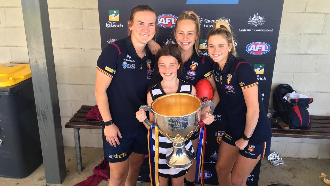 Sunshine Coast juniors from the Premiership winning Brisbane Lions AFLW side, Belle Dawes, Lily Postlethwaite and Shannon Campbell visited the Schools Footy day to display the Cup.