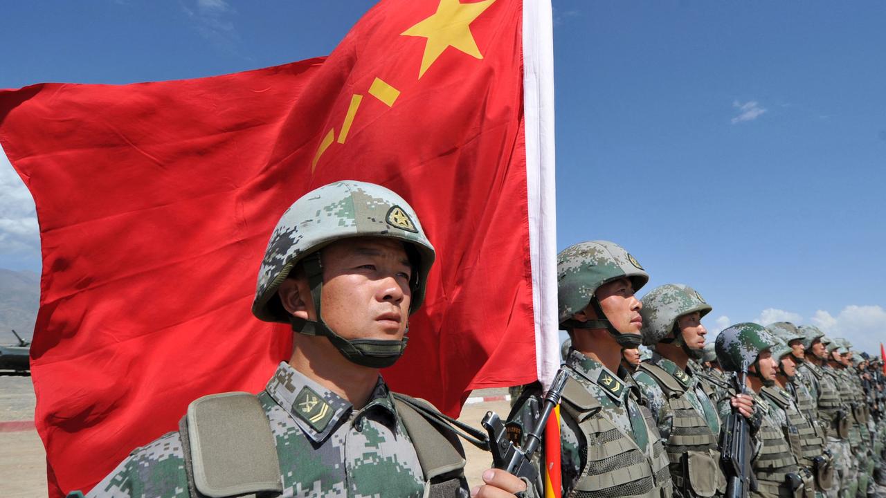 A Chinese soldier holds a Chinese flag during Peace Mission-2016. Picture: Vyacheslav Oseledko/AFP