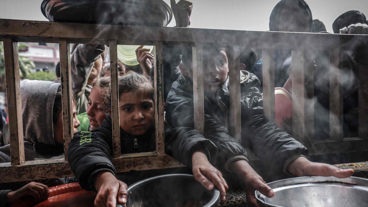 Displaced Palestinian children gather to receive food at a government school in Rafah in the southern Gaza Strip. Picture: AFP
