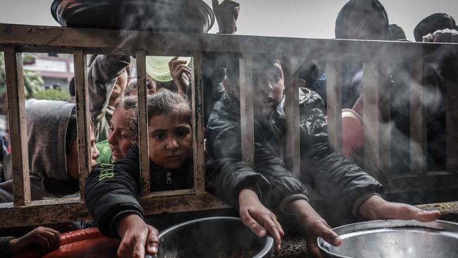 Displaced Palestinian children gather to receive food at a government school in Rafah in the southern Gaza Strip. Picture: AFP