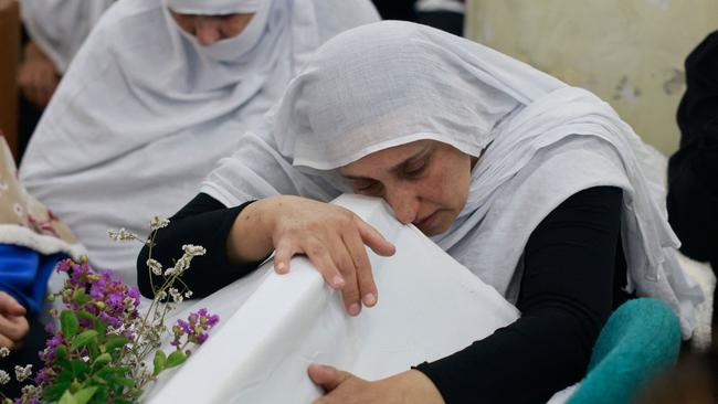 Druze women mourn near the coffin of a loved one after a reported strike from Lebanon fell in Majdal Shams village in the Israeli-annexed Golan area. Picture: AFP