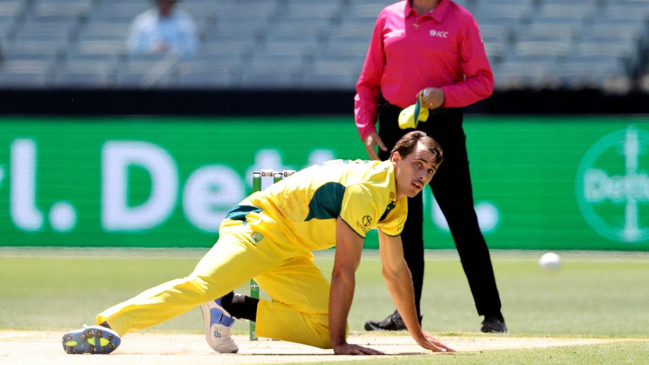 Australia's Lance Morris fields the ball in front of an empty row of chairs at the MCG on Friday. Picture: Martin Keep / AFP.