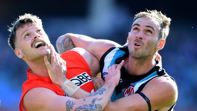 Peter Ladhams battles Jeremy Finlayson during a match against his former club Port Adelaide.