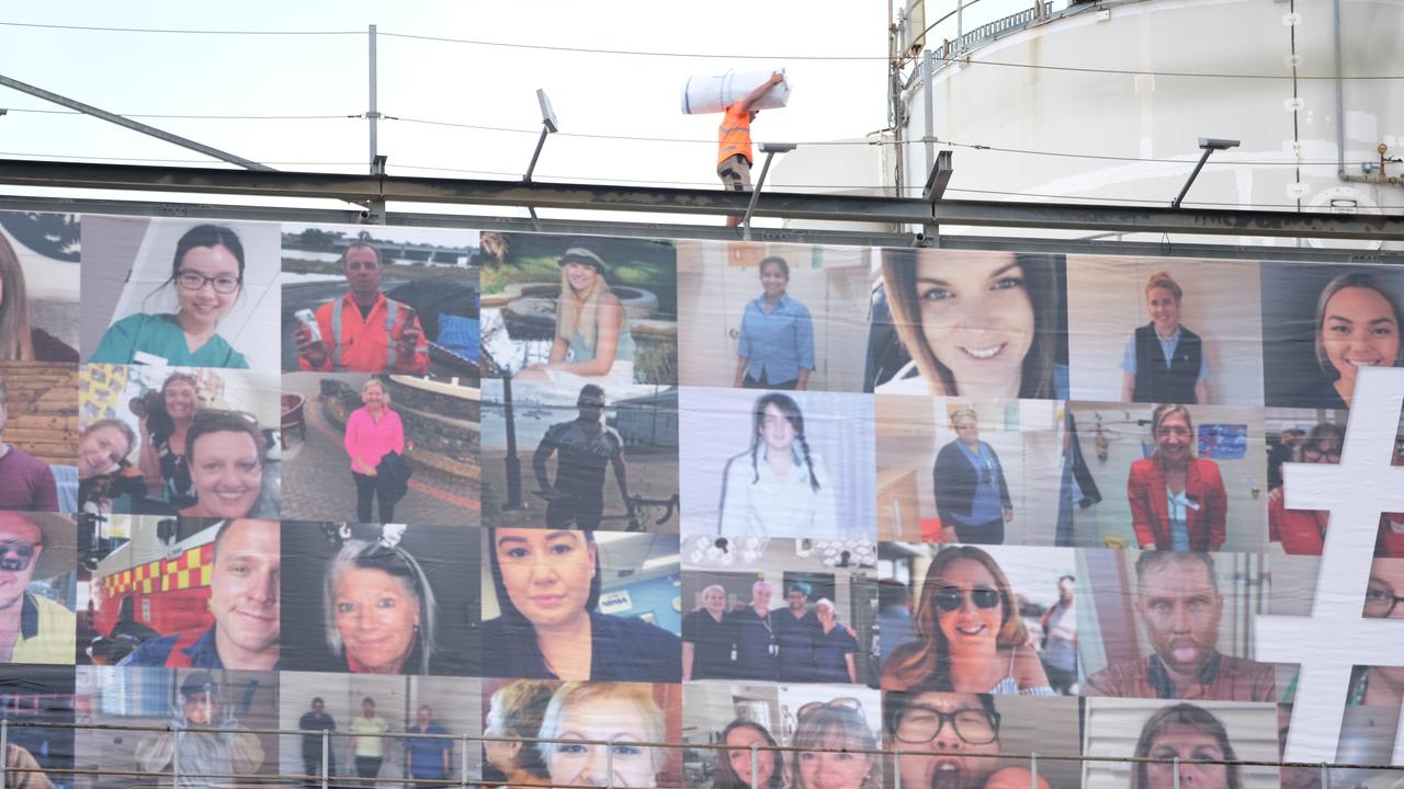 Faces of essential workers have filled the sign.