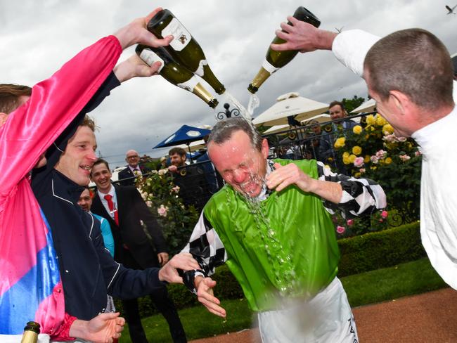 Baster is sprayed with champagne from fellow jockeys after riding in his last race.