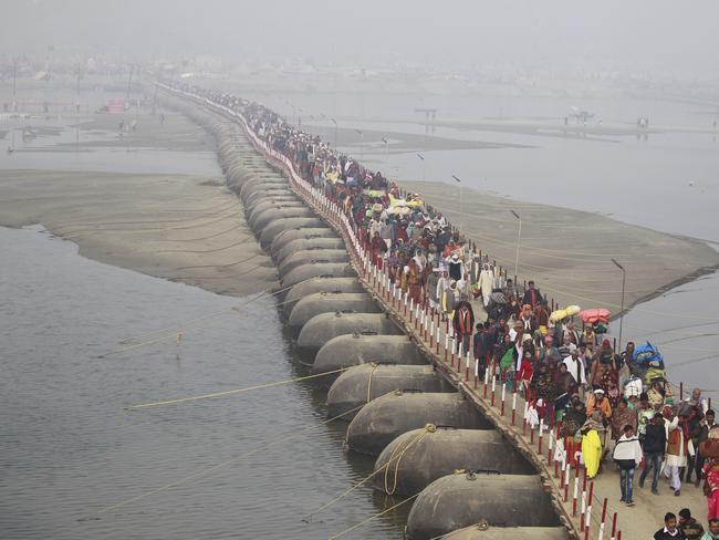 Indian Hindu pilgrims walk across a pontoon bridge on the eve of Mauni Amavasya, an important bathing day, at Sangam, the confluence of rivers Ganges, Yamuna, and mythical Saraswati during Kumbh Mela in Prayagraj, Uttar Pradesh state, India. Picture: AP