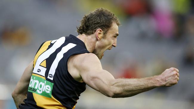 Shane Tuck punches the air in celebration after kicking a goal.