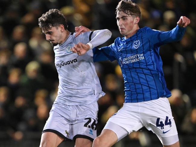 PORTSMOUTH, ENGLAND - JANUARY 28: Hayden Matthews of Portsmouth challenges Mihailo Ivanovic of Millwall during the Sky Bet Championship match between Portsmouth FC and Millwall FC at Fratton Park on January 28, 2025 in Portsmouth, England. (Photo by Mike Hewitt/Getty Images)